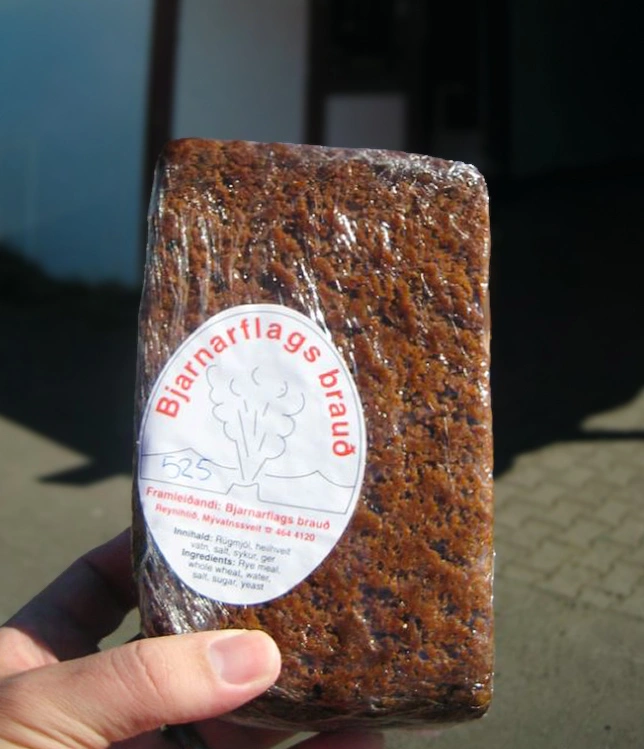 Hand holding geothermal bread in Iceland
