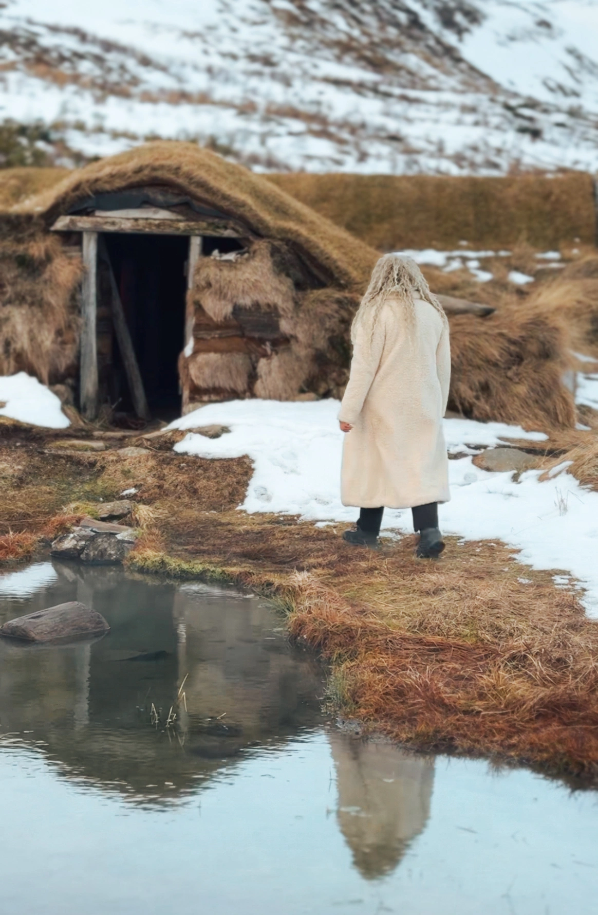 Woman walking towards the Sorcerer's Cottage in Iceland