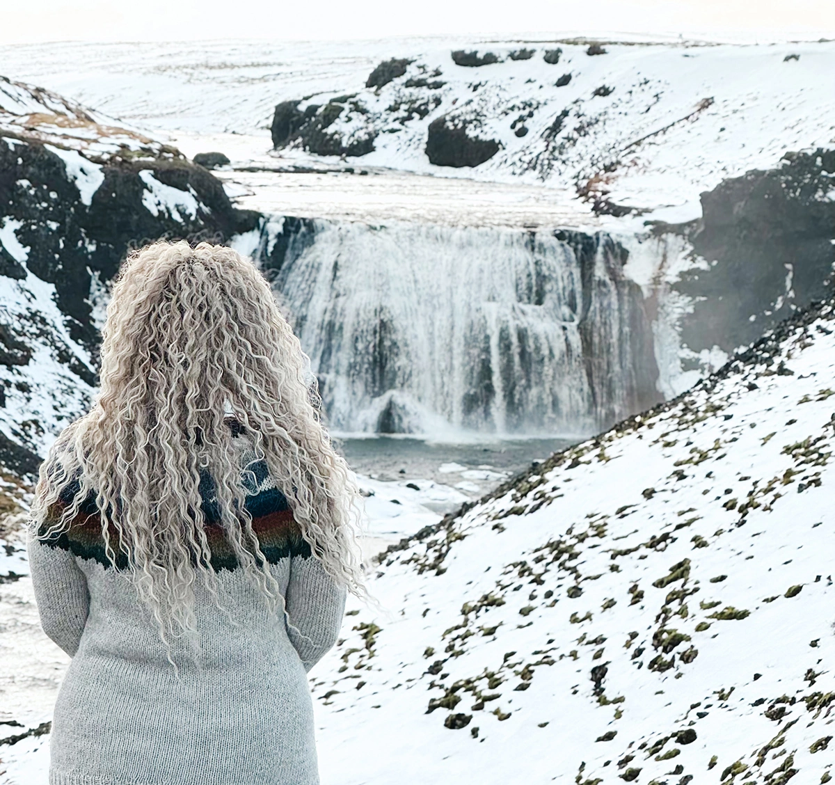 Woman looking at the waterfall in Iceland