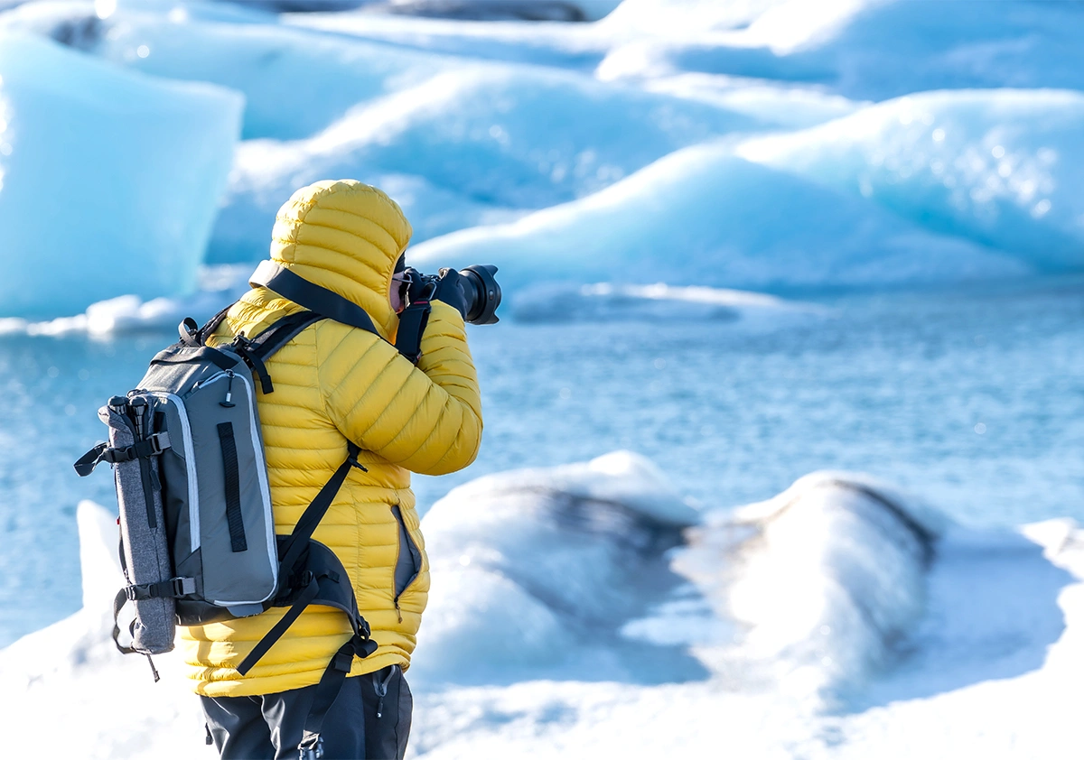 A man taking photo of a Jökulsárlón glacier in Iceland