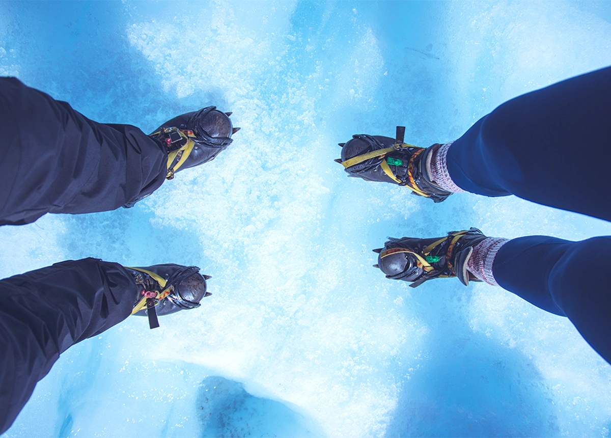 Couple wearing crampons on a glacier in Iceland