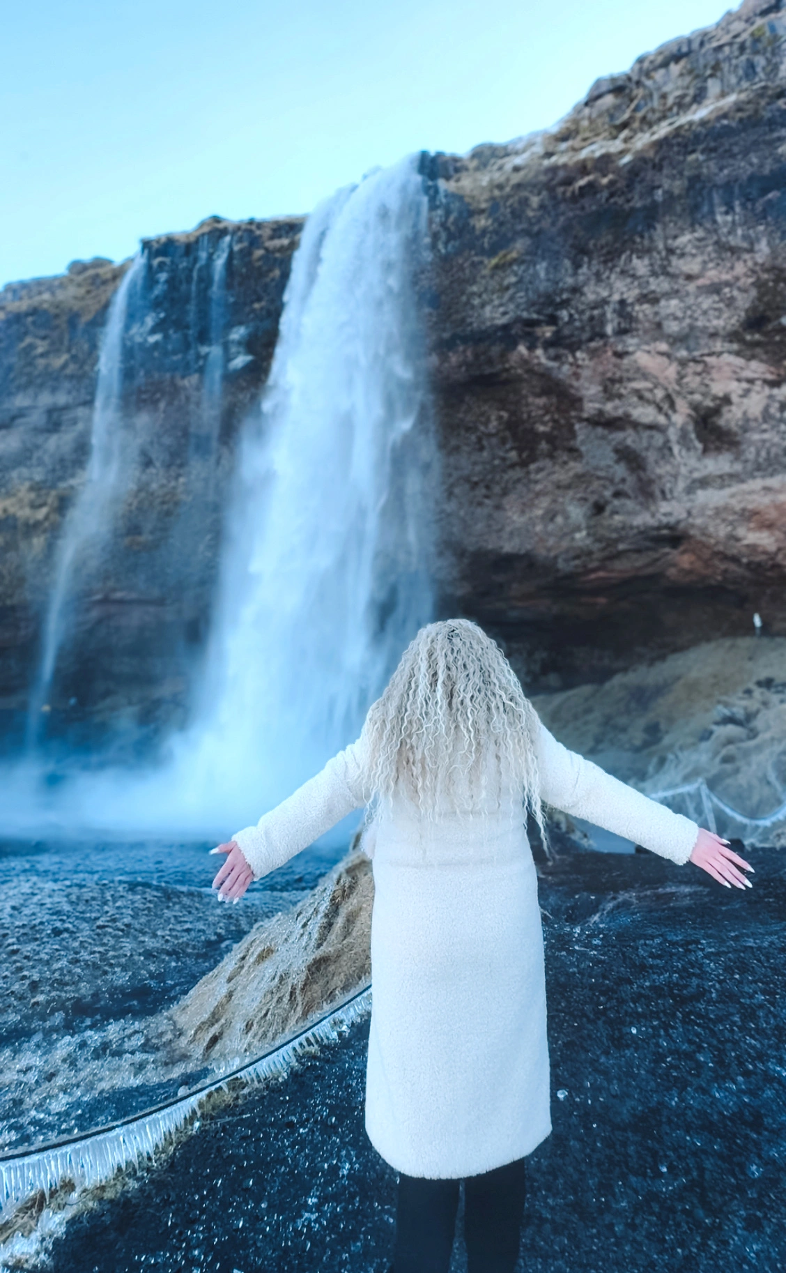 woman looking at the waterfall in Iceland